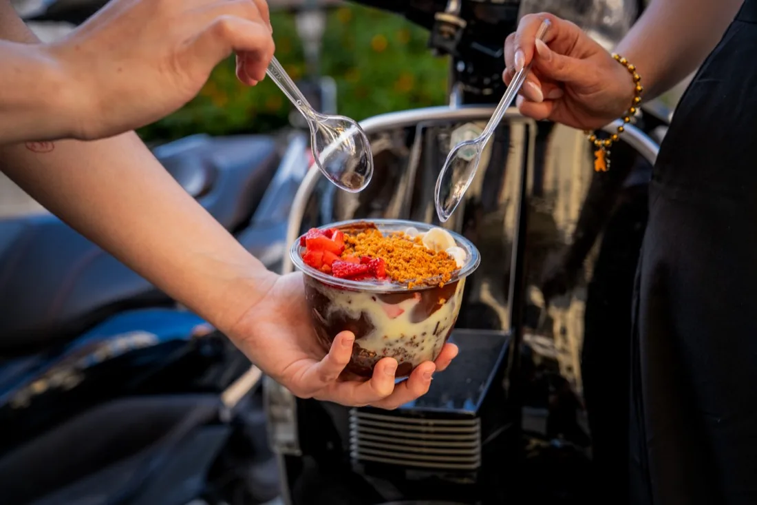 Bowl de açaí con dos cucharas al atardecer en Sevilla